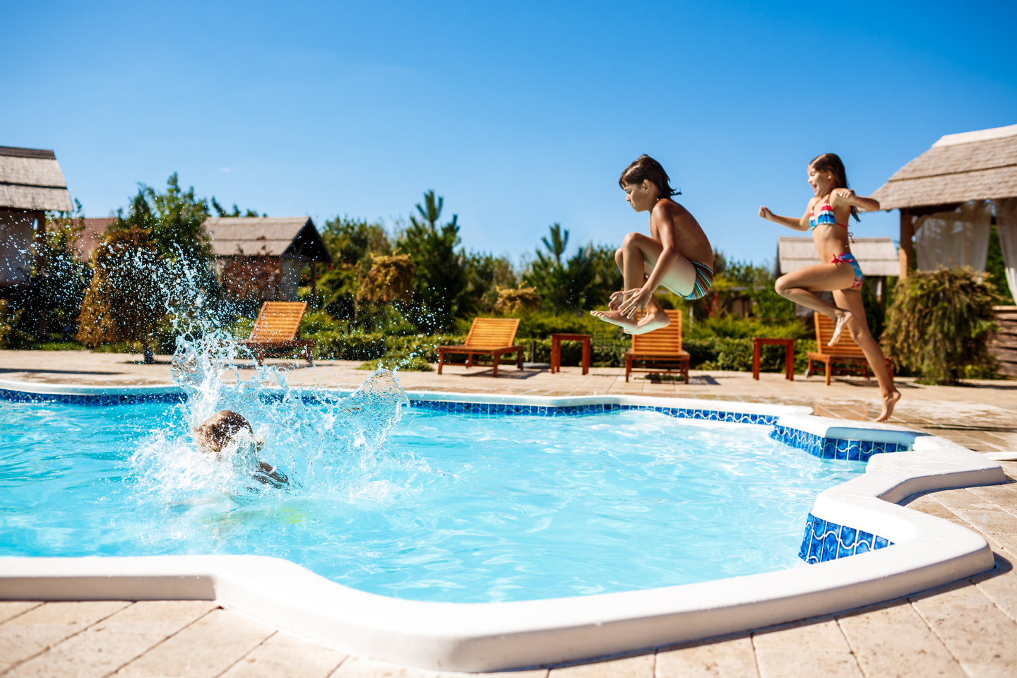 Kids jumping into the pool